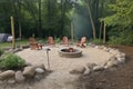 campsite with fire pit, lanterns, and chairs for comfortable evening outdoors