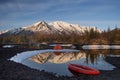 Campsite with orange tent and canoe on a lake