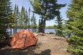 Campsite with orange tent and fire on a northern Minnesota lake Royalty Free Stock Photo