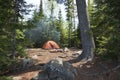 Campsite with orange tent and fire in the northern Minnesota wilderness