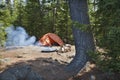 Campsite with orange tent and fire in the northern Minnesota wilderness Royalty Free Stock Photo