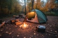 campsite with tent, lantern, and campfire for a warm and cozy stay