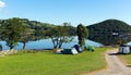 Campsite tents Ullswater Lake District Cumbria England UK with mountains and blue sky on beautiful day Royalty Free Stock Photo