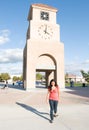 Campus Clock Tower With Student Walking