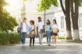 Campus Life. Group of international students walking outdoors after classes Royalty Free Stock Photo