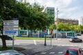 Campus Nord sign post with moving tram behind in Barcelona