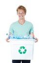 We can all make a difference. A happy young red-headed man holding a recycling bin filled with empty plastic bottles. Royalty Free Stock Photo