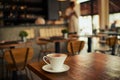 Can anyone see me. a freshly brewed cup of coffee standing on a table by its own inside of a restaurant during the day. Royalty Free Stock Photo