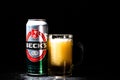 Can of Beck`s or Becks beer and beer glass on dark background. Illustrative editorial photo shot in Bucharest, Romania, 2021