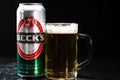 Can of Beck`s or Becks beer and beer glass on dark background. Illustrative editorial photo shot in Bucharest, Romania, 2021