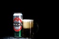 Can of Beck`s or Becks beer and beer glass on dark background. Illustrative editorial photo shot in Bucharest, Romania, 2021