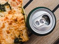 Can of beer and a piece of pizza. Top view Royalty Free Stock Photo