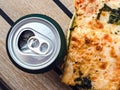 Can of beer and a piece of pizza. Top view Royalty Free Stock Photo