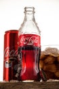 Can, bottle and glass of Coca-Cola with ice on wooden background Royalty Free Stock Photo