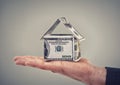 He can buy his dream home now. Close up conceptual shot of a man holding money that has been made to look like a house. Royalty Free Stock Photo