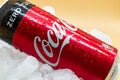 Can of Coca Cola on ice with water droplets. Royalty Free Stock Photo