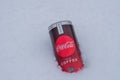 Can of Coca-Cola plus coffee on a bed of snow and white background Royalty Free Stock Photo