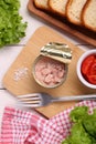 Can of conserved tuna, tomatoes and bread on white wooden table, flat lay