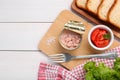 Can of conserved tuna, tomatoes and bread on white wooden table, flat lay. Space for text