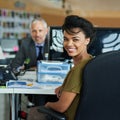 We can design anything. Portrait of two coworkers sitting at their workstations in an office. Royalty Free Stock Photo