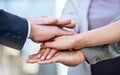 We can do this. Shot of a group of unrecognizable businesspeople stacking their hands.