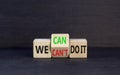 We can do it symbol. Concept word We can or can not do it on beautiful wooden cubes. Beautiful black table black background.