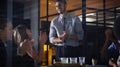 We can do this together. a diverse group of businesspeople clapping after a successful meeting in the office late at Royalty Free Stock Photo