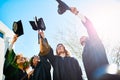 We can finally let loose now. a group of students throwing their caps into the air after graduating. Royalty Free Stock Photo