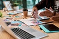 We can only have one. two unrecognizable businesspeople sitting together and having a meeting over polaroids in the Royalty Free Stock Photo