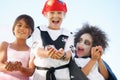 Can we have some more, please. Costumed children holding out their hands for candy at Halloween. Royalty Free Stock Photo