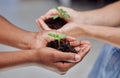 We can help each other grow. two unrecognizable people holding plants growing out of soil. Royalty Free Stock Photo