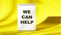 We can help text on white notepad Royalty Free Stock Photo