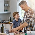 Can I also do it. a father and his son making pizza at home. Royalty Free Stock Photo