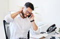 Can I book an appointment this week please. a handsome young businessman sitting alone in the office and suffering from Royalty Free Stock Photo