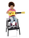 Can I take any requests. Studio shot of a cute little girl playing with her toy guitar against a white background. Royalty Free Stock Photo