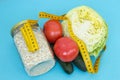 A can of oatmeal, tomatoes, cucumbers, cabbage and tape measure. The concept of proper nutrition to maintain beauty and health. We Royalty Free Stock Photo