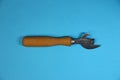 Can opener with wooden handle on blue background Royalty Free Stock Photo