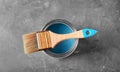 Can of paint and brush on grey background Royalty Free Stock Photo