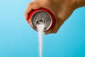 Can pouring sugar stream in calories content of soda energetic and refreshing drinks Royalty Free Stock Photo