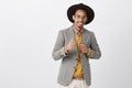 He can rely on you. Portrait of satisfied confident african-american guy in black hat and stylish jacket, showing gun