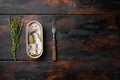Can of sardines in olive oil, on old dark  wooden table background, top view flat lay, with copy space for text Royalty Free Stock Photo