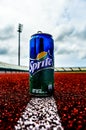 Can of sprite soda on track field in stadium