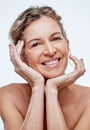 We can take steps to help our skin stay supple and fresh-looking. a beautiful mature woman posing against a white
