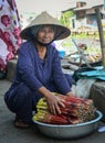 A vendor at market in Mekong Delta, Vietnam