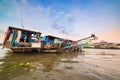 Can Tho, Vietnam - january 7, 2020: Cai Rang floating market at sunrise, boats selling wholesale fruits and goods on Can Tho River