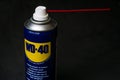 Can of WD-40 aerosolum on black background, illustrative editorial image