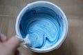 Can of white-blue paint with a brush, top view. Royalty Free Stock Photo