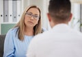 Can you give me more detail. a mature psychiatrist sitting with her patient during a consultation in her clinic. Royalty Free Stock Photo