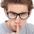 Can you keep a secret. Young handsome man gesturing for you to be quiet. Royalty Free Stock Photo