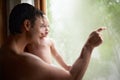 Can you see that, darling. A young father holding his baby girl and showing her something beyond the window. Royalty Free Stock Photo